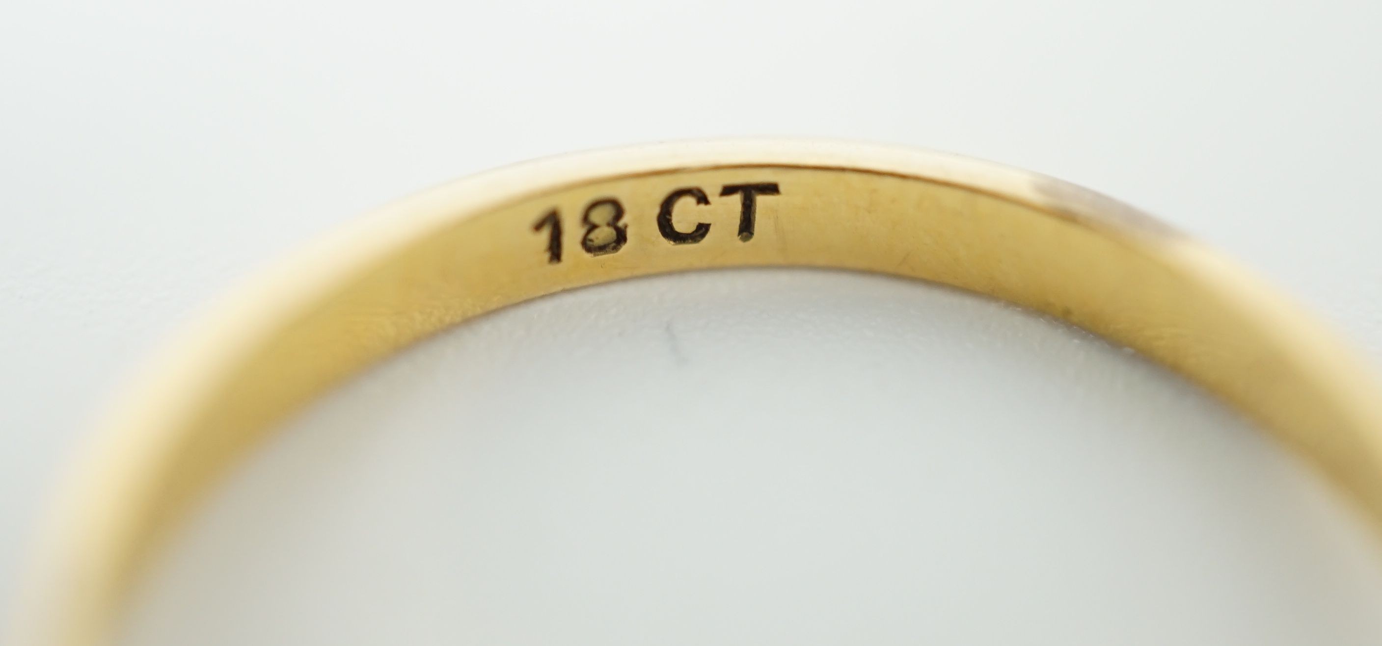 An 18ct gold, graduated three stone sapphire and two stone diamond set half hoop ring